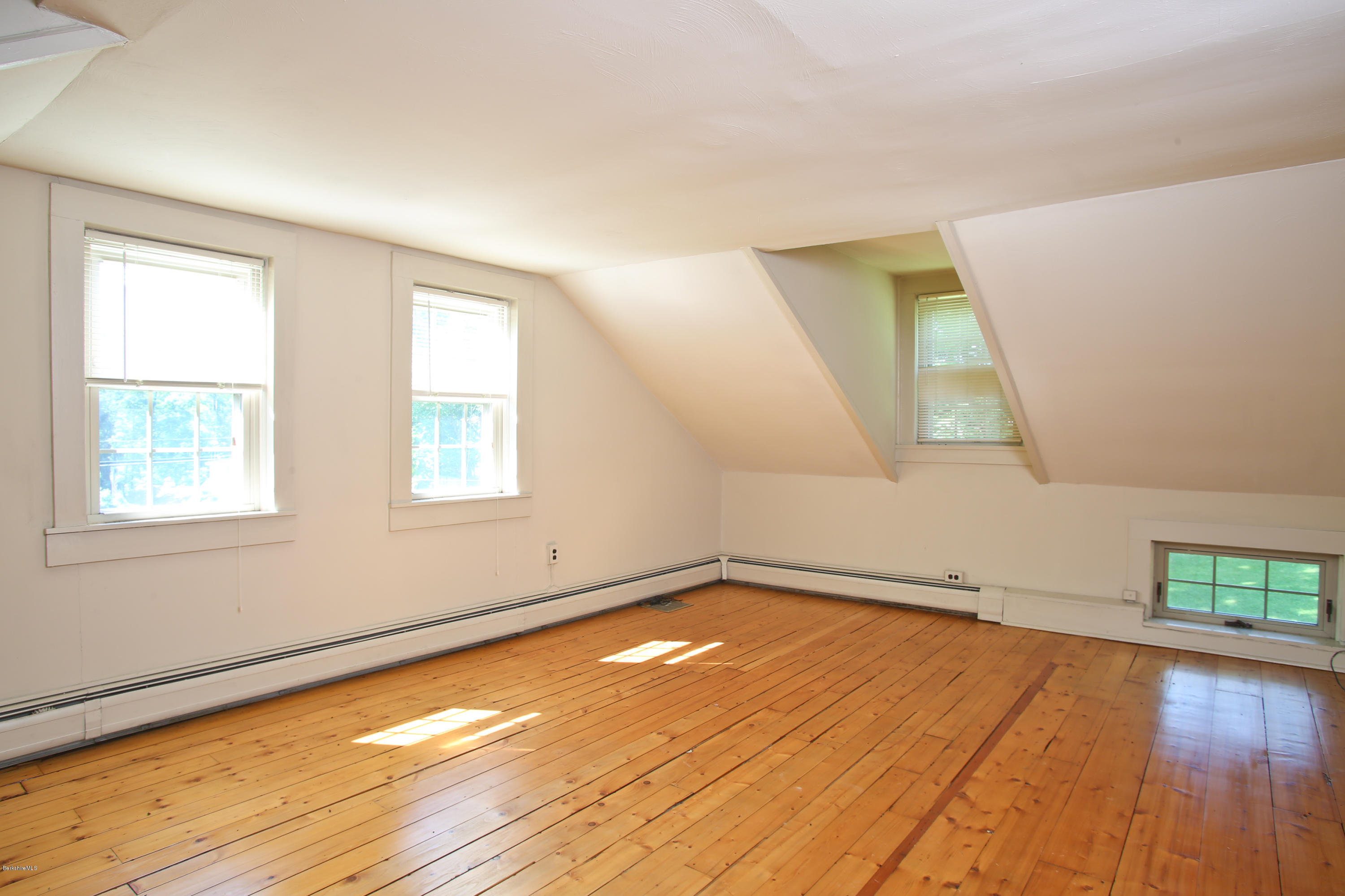 759 Hancock Road Williamstown, MA 01267 - Photo 66 of 71 an empty room with wooden floor and windows