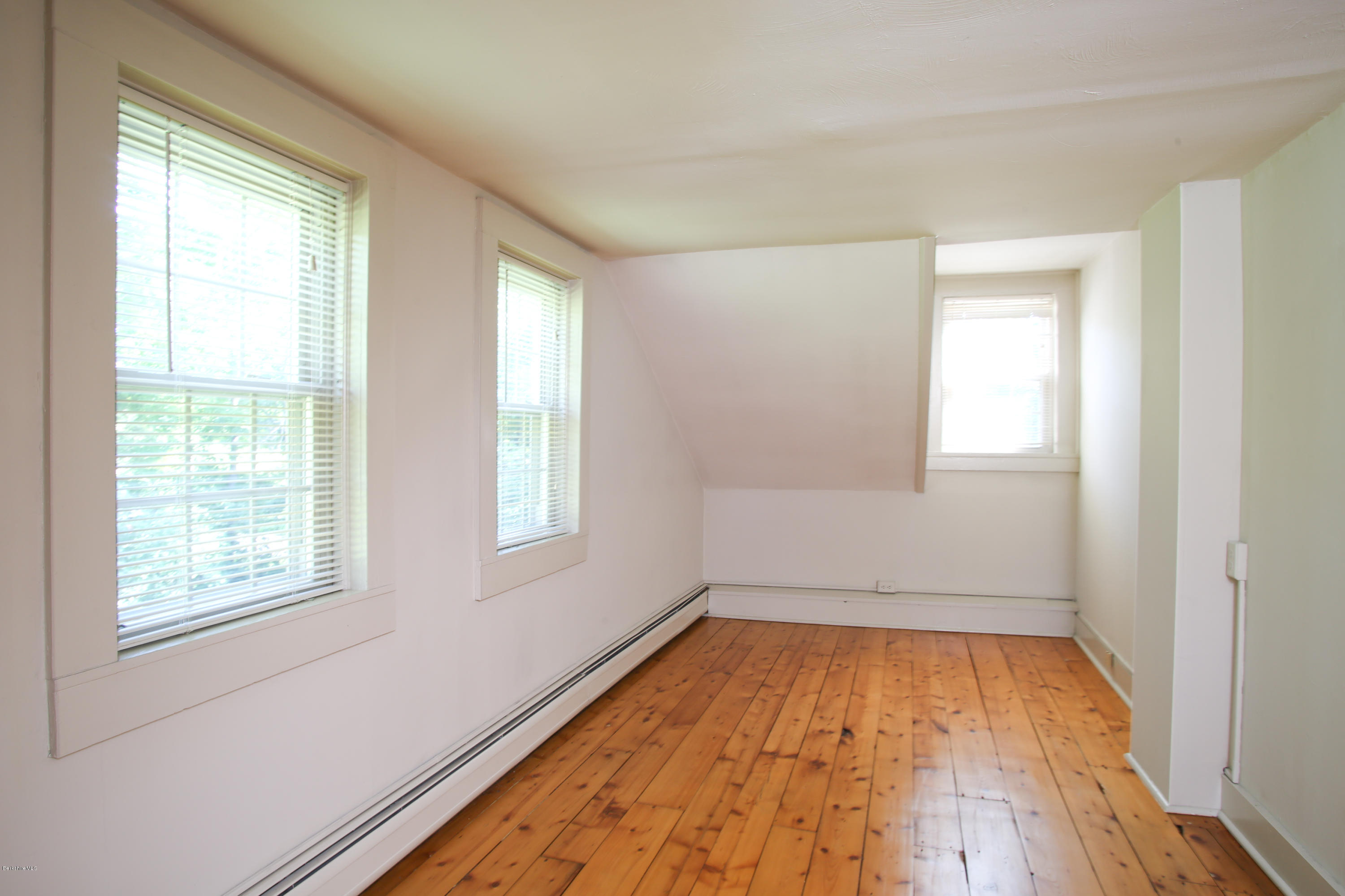 759 Hancock Road Williamstown, MA 01267 - Photo 67 of 71 an empty room with wooden floor and windows
