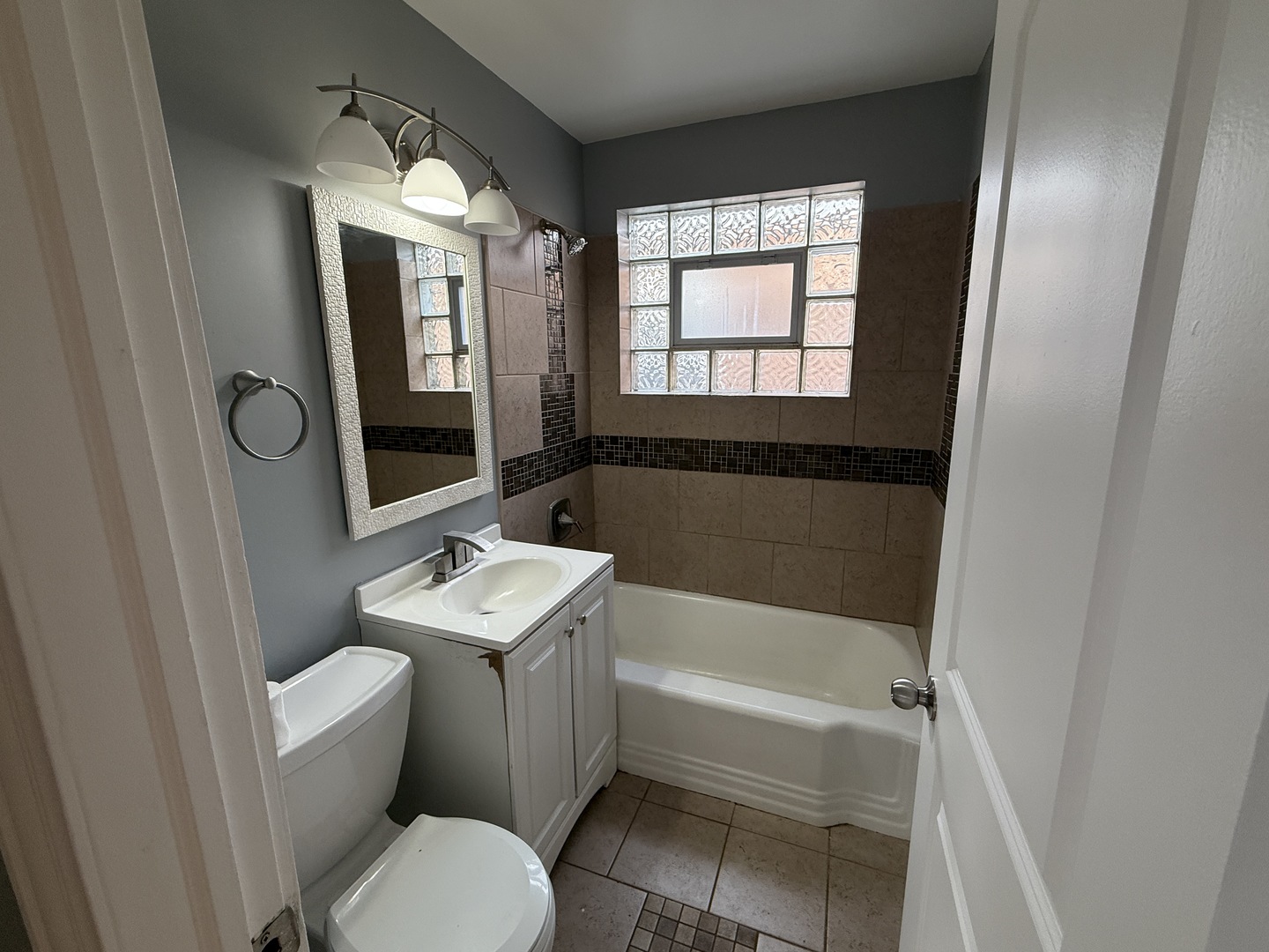 9710 South Chappel Avenue Chicago, IL 60617 - Photo 7 of 11 a bathroom with a sink toilet and shower
