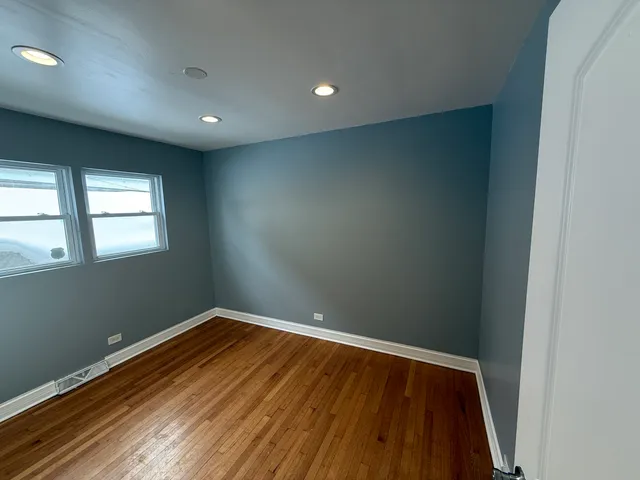 a view of room with window and wooden floor