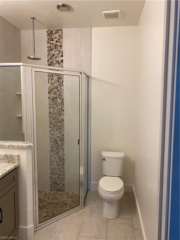 5314 30th Street Southwest Lehigh Acres, FL 33973 - Photo 13 of 19 a bathroom with a toilet and a shower