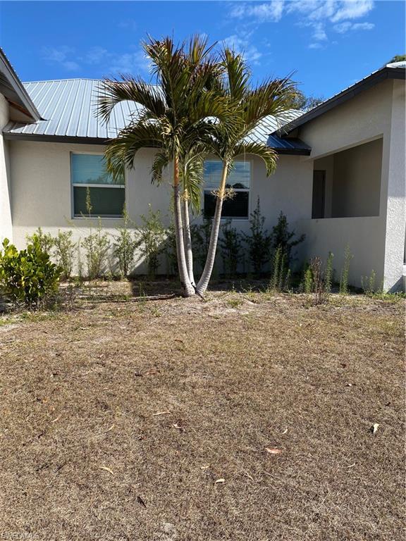5314 30th Street Southwest Lehigh Acres, FL 33973 - Photo 18 of 19 a front view of a house with garden