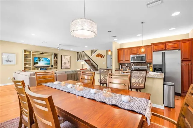a kitchen with stainless steel appliances granite countertop a sink and a living room