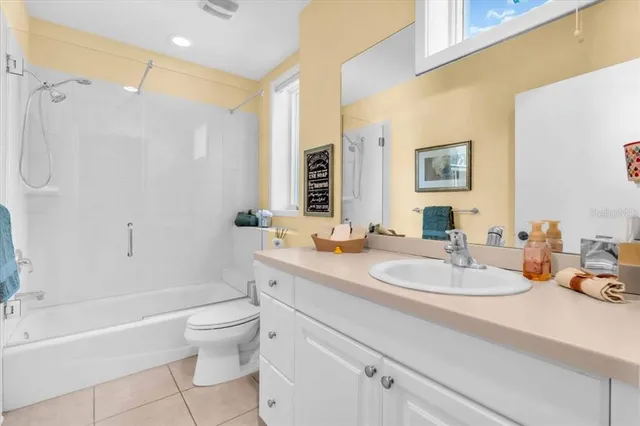 a bedroom with two beds and painting on the wall