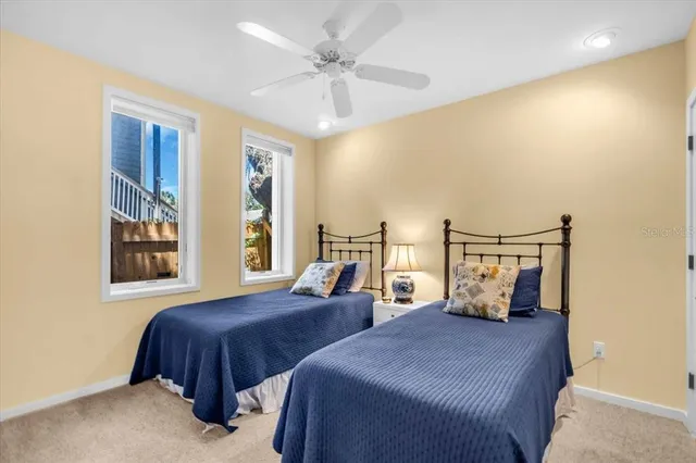 a bedroom with a bed and ceiling fan