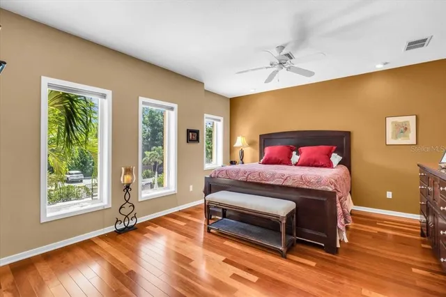 a bedroom with a bed and dresser with mirror