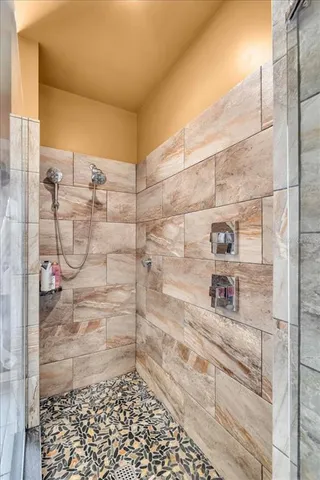 a bathroom with a granite countertop sink toilet and shower