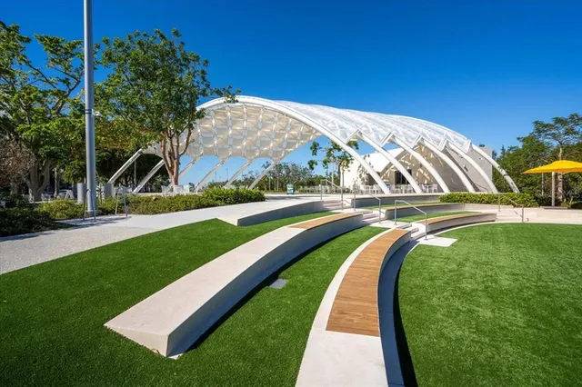 a view of a swimming pool with a patio and a yard
