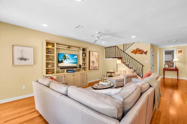 a view of a bedroom with wooden floor and stairs