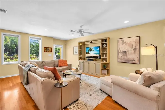 a living room with furniture and a wooden floor