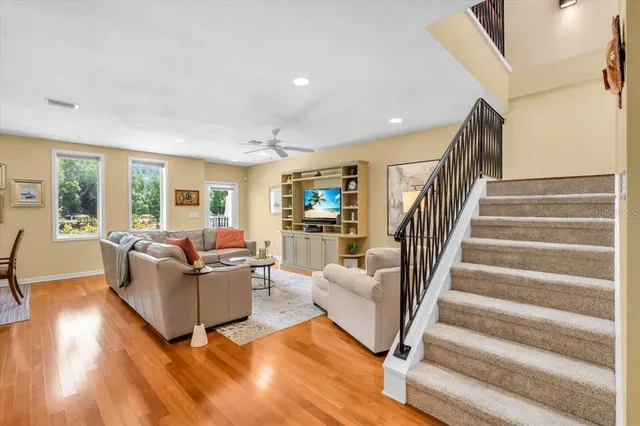 a kitchen with a stove a sink a refrigerator dining table and chairs