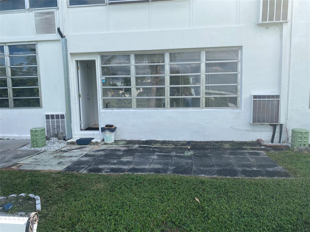 51 Northeast 204th Street, Unit 2 Miami, FL 33179 - Photo 13 of 18 a front view of a house with a yard