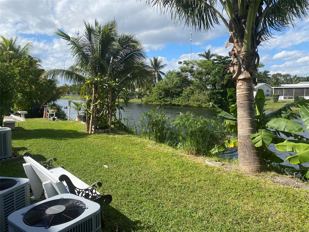 51 Northeast 204th Street, Unit 2 Miami, FL 33179 - Photo 16 of 18 a view of backyard with outdoor seating and green space