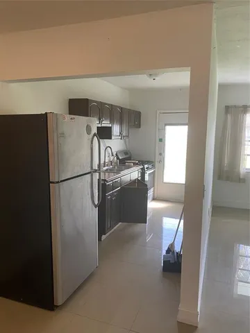 a kitchen with a refrigerator a stove and a refrigerator