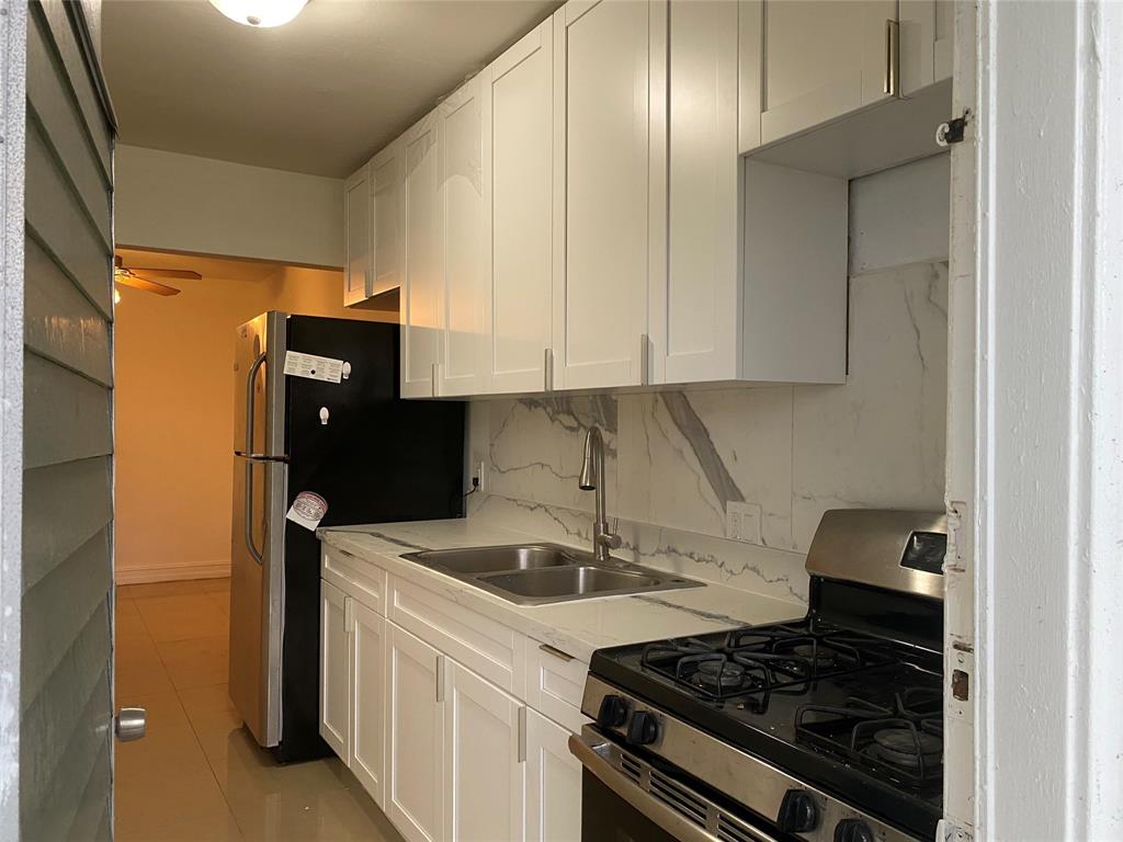 51 Northeast 204th Street, Unit 2 Miami, FL 33179 - Photo 3 of 18 a kitchen with a stove and a refrigerator