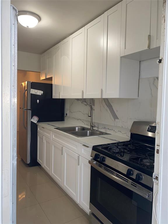51 Northeast 204th Street, Unit 2 Miami, FL 33179 - Photo 5 of 18 a kitchen with stainless steel appliances granite countertop a stove and a refrigerator