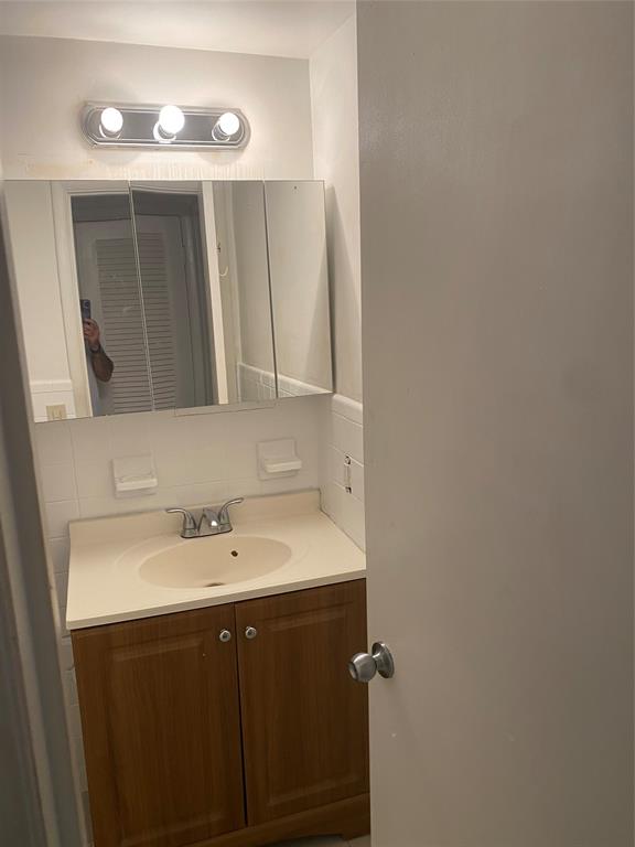 51 Northeast 204th Street, Unit 2 Miami, FL 33179 - Photo 7 of 18 a bathroom with a sink and a mirror