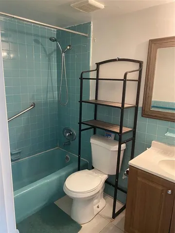 a bathroom with a toilet a sink and shower