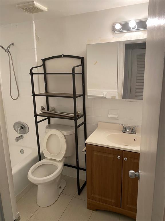 51 Northeast 204th Street, Unit 2 Miami, FL 33179 - Photo 8 of 18 a bathroom with a toilet sink and mirror