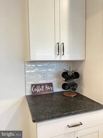 a white toilet sitting next to a white wall