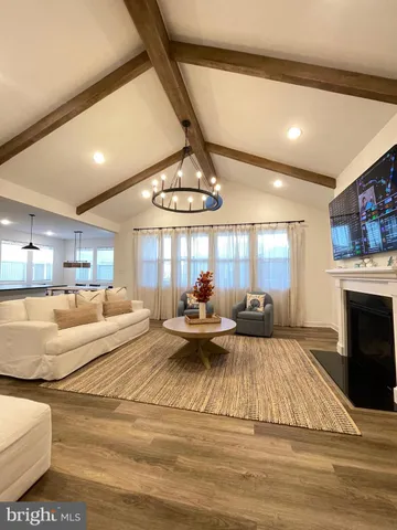 a kitchen with stainless steel appliances granite countertop a stove a sink and white cabinets