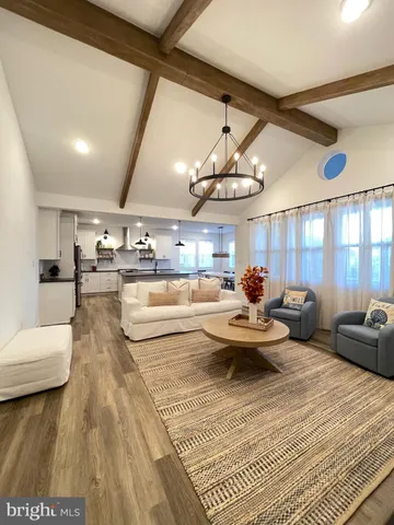 a kitchen with stainless steel appliances kitchen island granite countertop a sink a stove and chairs