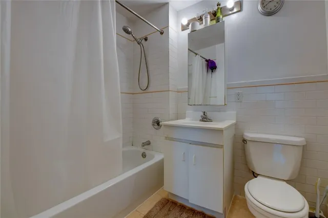 a bathroom with a sink vanity mirror and toilet