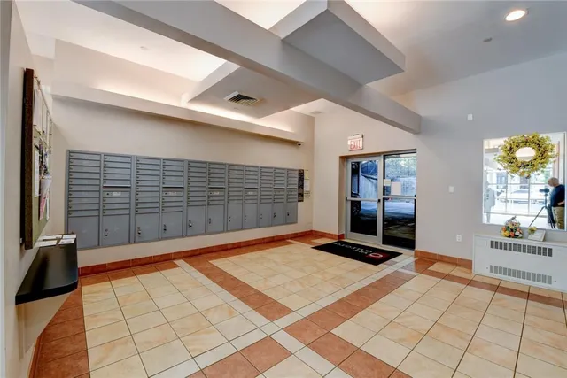 a bedroom with bed and mirror