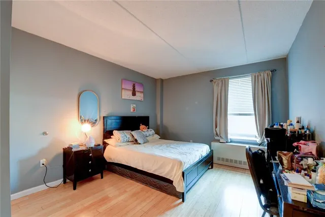 a bedroom with a bed and a desk