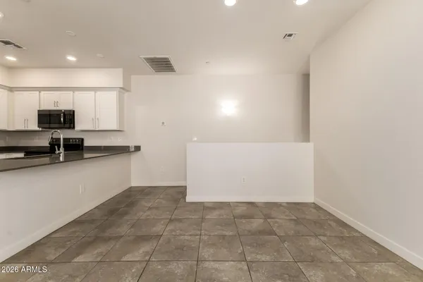 a view of kitchen with sink and cabinets