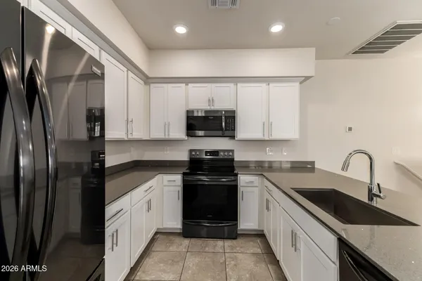 a kitchen with a sink stove and refrigerator