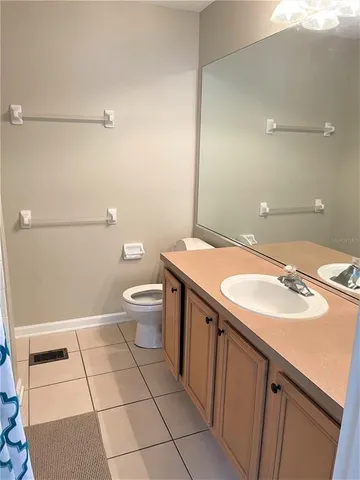 a bathroom with a sink a toilet a mirror and vanity