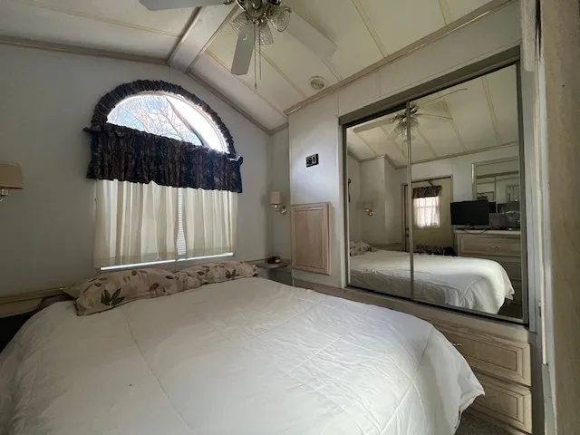 a bedroom with a bed and a large window