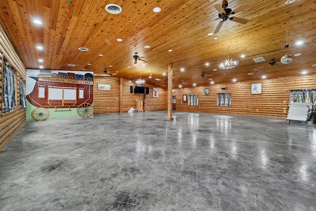 a room with pool table windows and fire pit