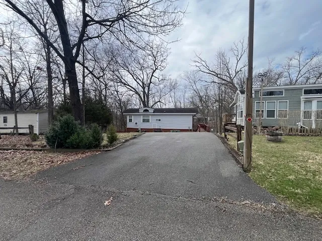 a view of road with yard and trees