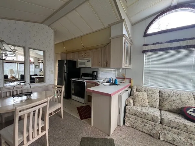 a kitchen with a sink stove and cabinets