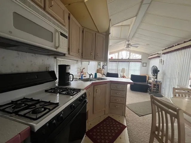 a kitchen with stainless steel appliances granite countertop a stove and a microwave