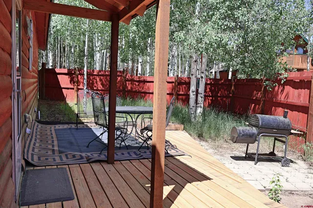 a view of a patio with table and chairs and wooden floor