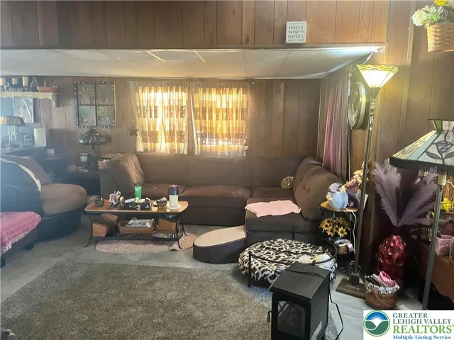 a living room with furniture and flowers