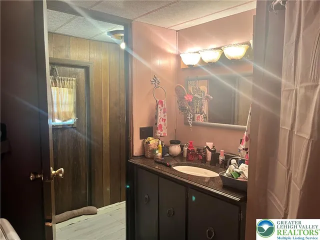 a bedroom with a bed and a mirror