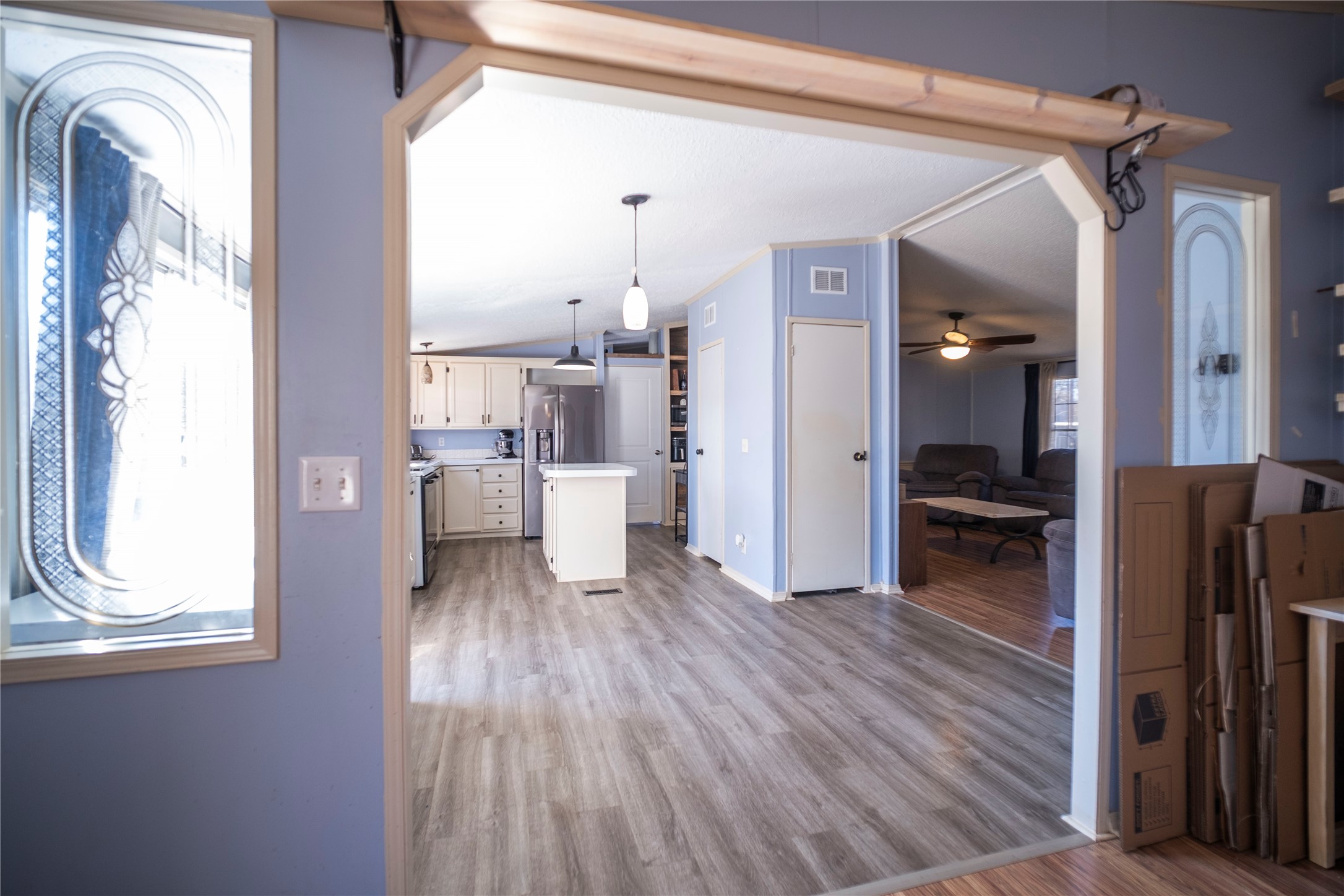 5406 Five Oaks Drive Spring, TX 77389 - Photo 16 of 26 Archway with wood-style flooring looking into kitchen.