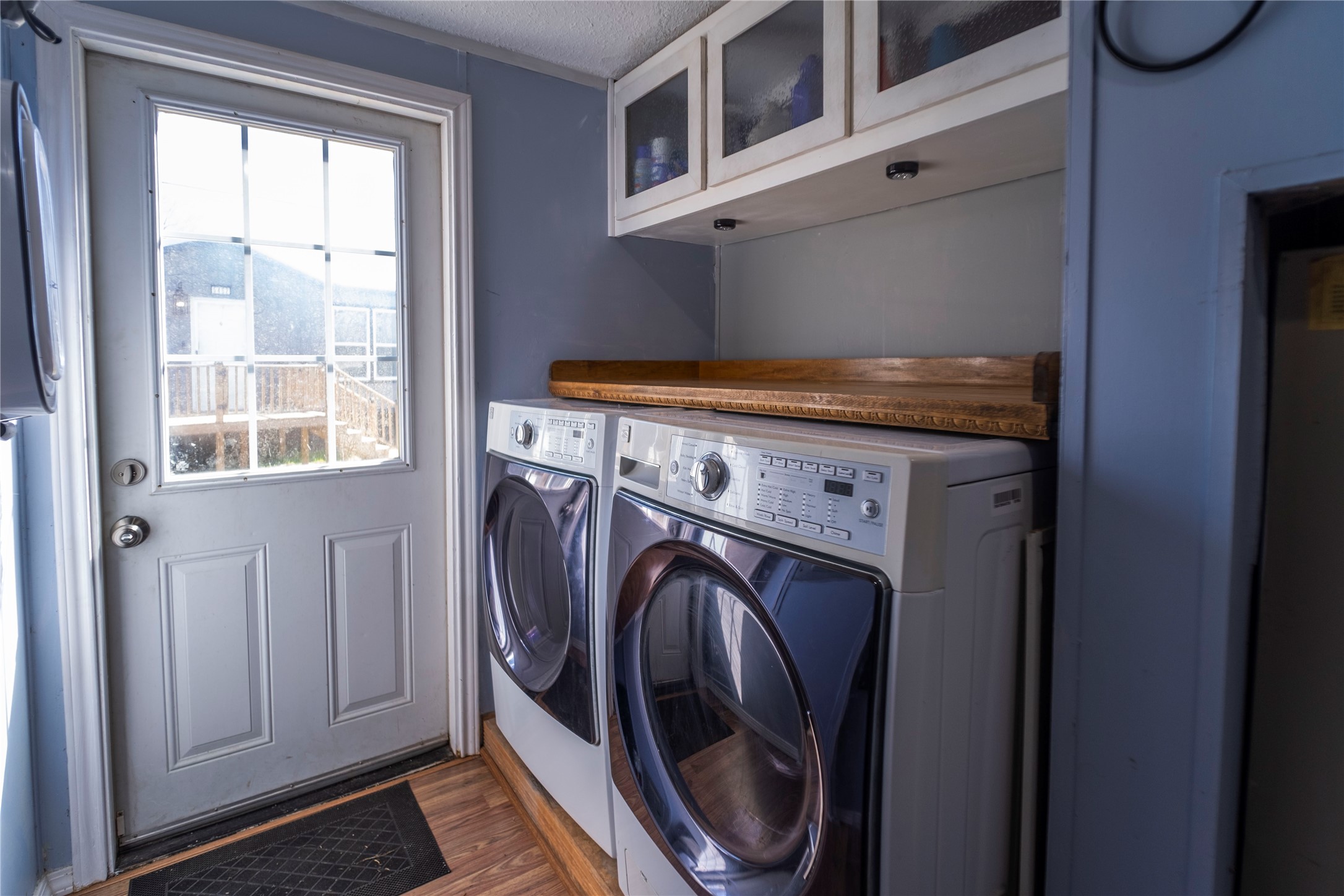 5406 Five Oaks Drive Spring, TX 77389 - Photo 24 of 26 Laundry area with washer and dryer connections leading to back door.