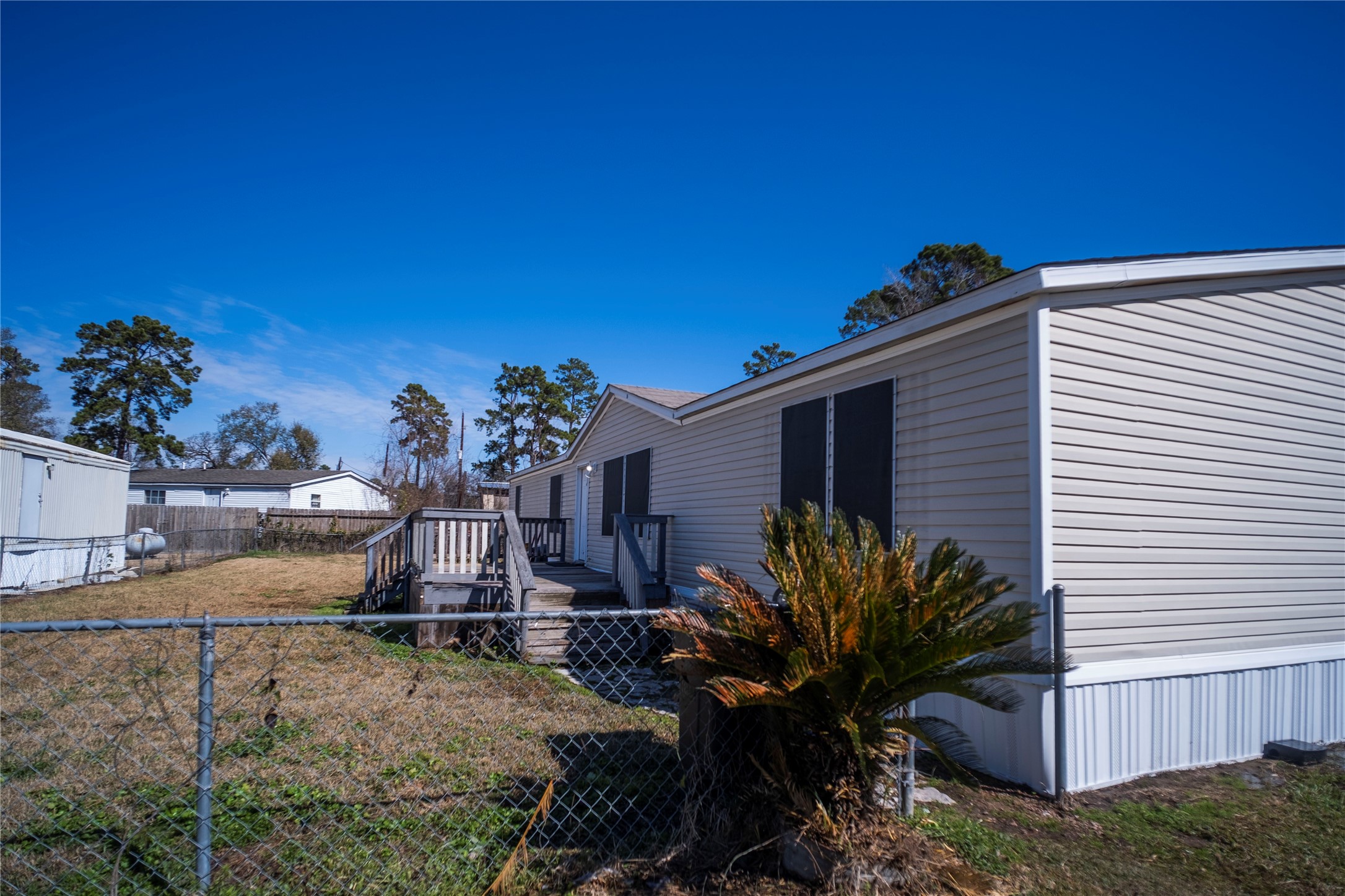 5406 Five Oaks Drive Spring, TX 77389 - Photo 26 of 26 Rear exterior view with open yard and trees.