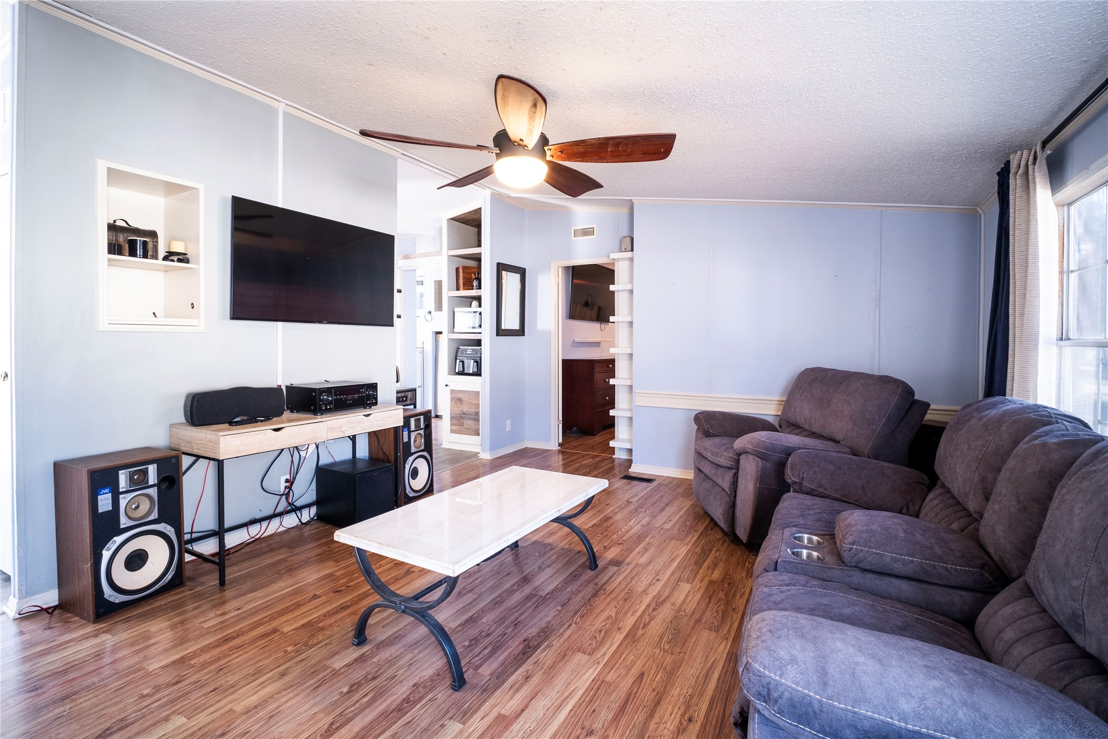 5406 Five Oaks Drive Spring, TX 77389 - Photo 4 of 26 Open living area with wood-style flooring and ceiling fan.