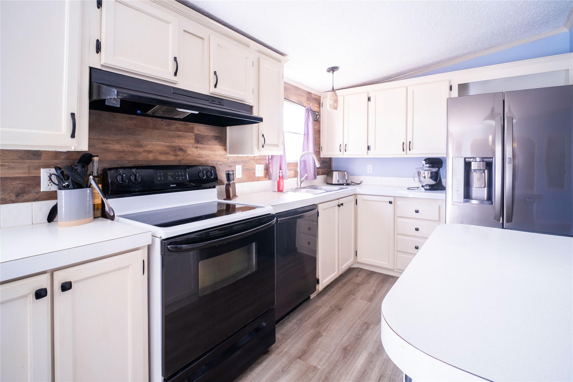 5406 Five Oaks Drive Spring, TX 77389 - Photo 8 of 26 Kitchen featuring white cabinetry and updated appliances.