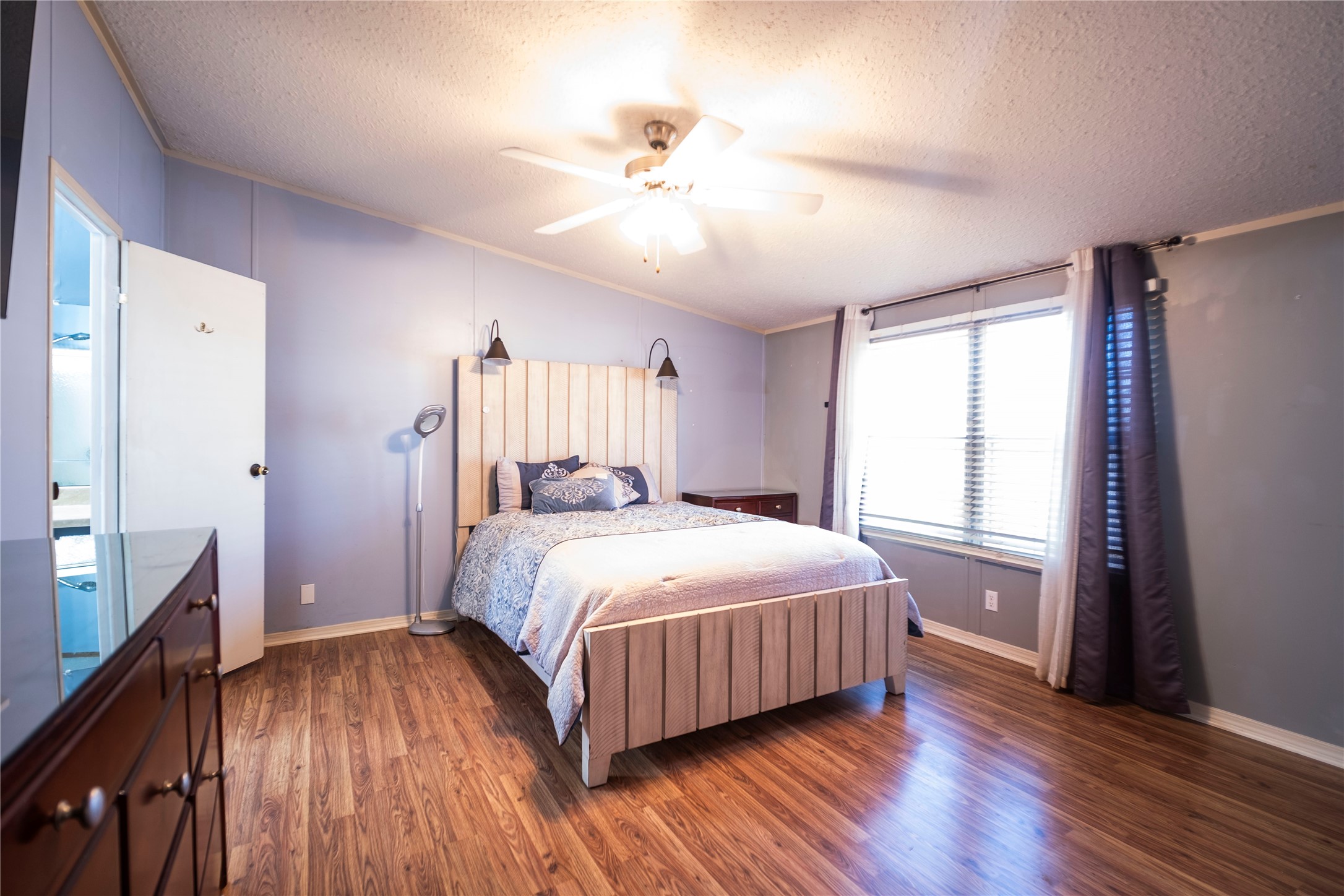 5406 Five Oaks Drive Spring, TX 77389 - Photo 9 of 26 Primary Bedroom with wood-style flooring and ceiling fan.