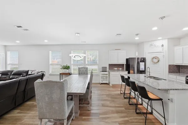 a view of a dining room with furniture and wooden floor