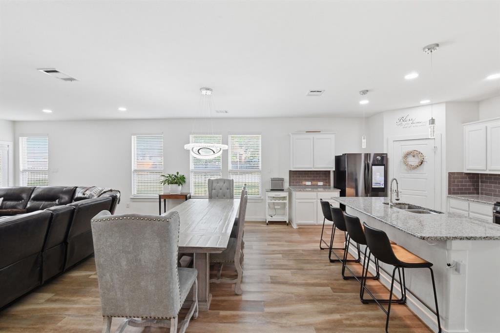 7645 Spring Drive Watauga, TX 76148 - Photo 12 of 28 a view of a dining room with furniture and wooden floor
