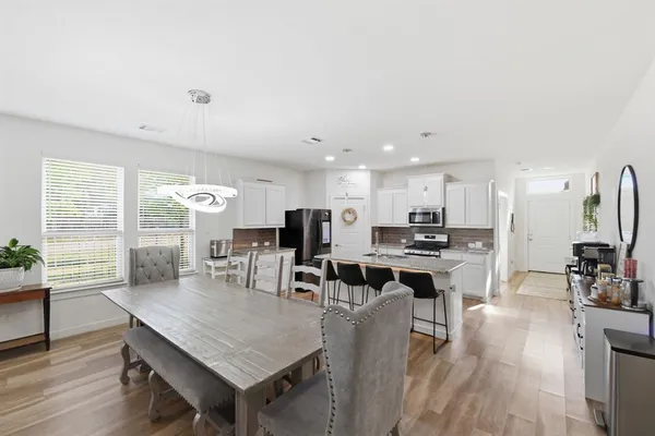a view of a dining room with furniture window and wooden floor