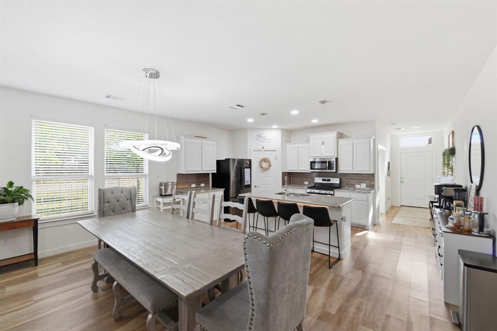 7645 Spring Drive Watauga, TX 76148 - Photo 15 of 28 a view of a dining room with furniture window and wooden floor